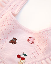 Load image into Gallery viewer, Close-up of a pink knitted dog bandana with embroidered teddy bear, cherries, and bow design.