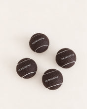 Load image into Gallery viewer, Chocolate brown dog tennis ball with white detailing and The Deluxe Pup logo
