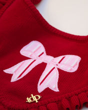 Load image into Gallery viewer, Red sweater with a pink bow design and gold logo on a white background
