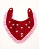 Red dog bandana with pink trim and heart patterns on a white background