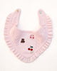 Pink knitted dog bandana with embroidered designs on a white background