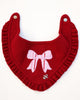 Red knitted dog bandana with a pink bow design on a white background